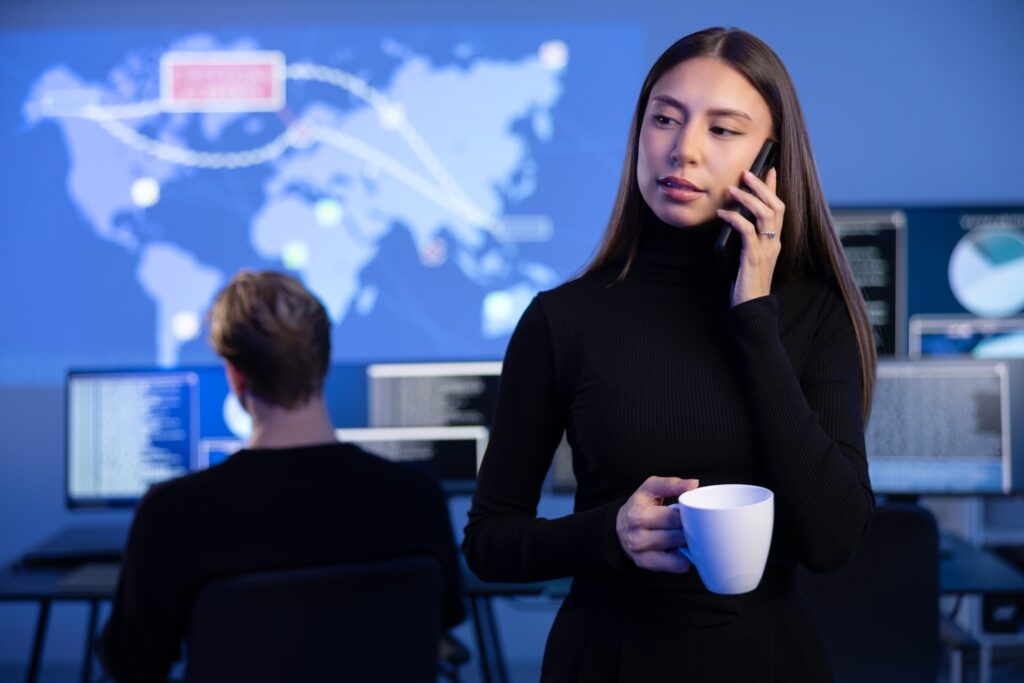 Female Cybersecurity Manager talking in the phone in Enterprise Cyber Security Operations Center SOC